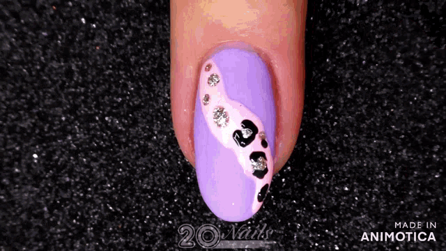 a purple nail with a leopard print and rhinestones made in animatica