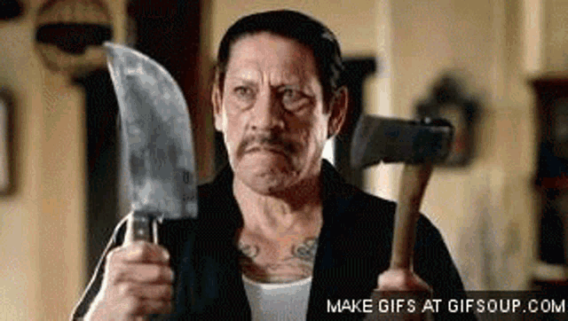 a man is holding a large knife and a hammer .