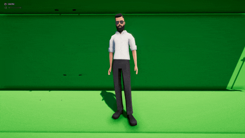 a man with a beard and glasses is standing in front of a green wall