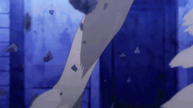 a close up of a person 's arm with pieces of paper flying in the air