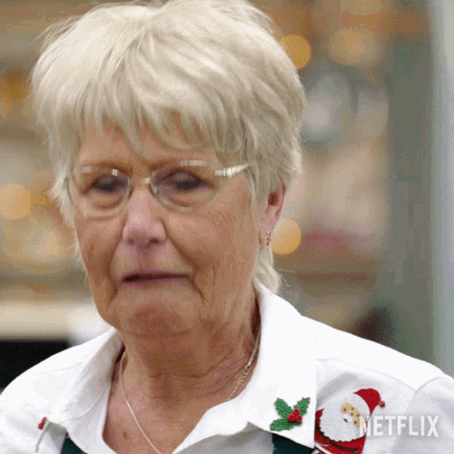 an older woman wearing glasses and a netflix sweater