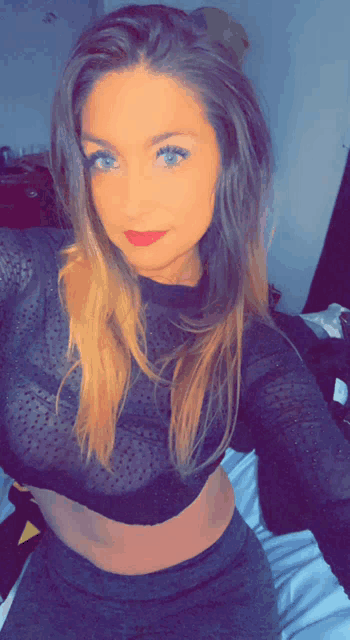 a woman taking a selfie in a sheer top