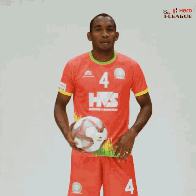 a soccer player wearing a red jersey with the number 4 on it
