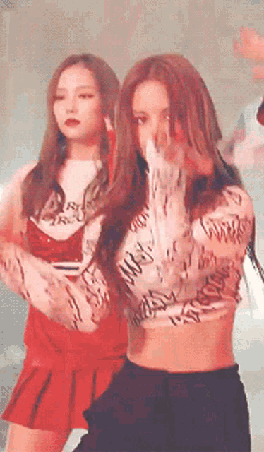 a woman wearing a crop top that says ' ncw ' on it