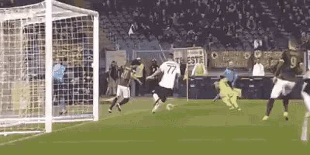 a group of soccer players are playing on a field .
