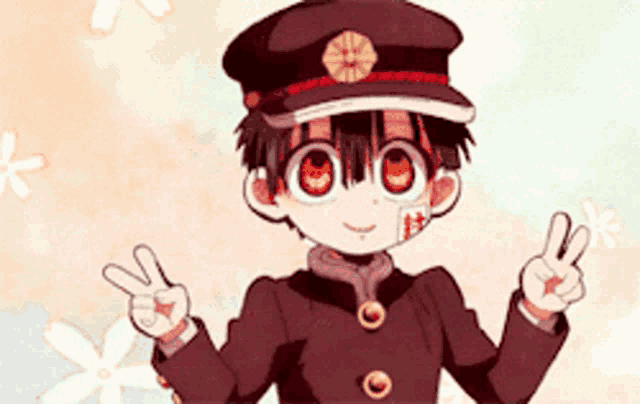 a young boy in a hat is giving a peace sign .