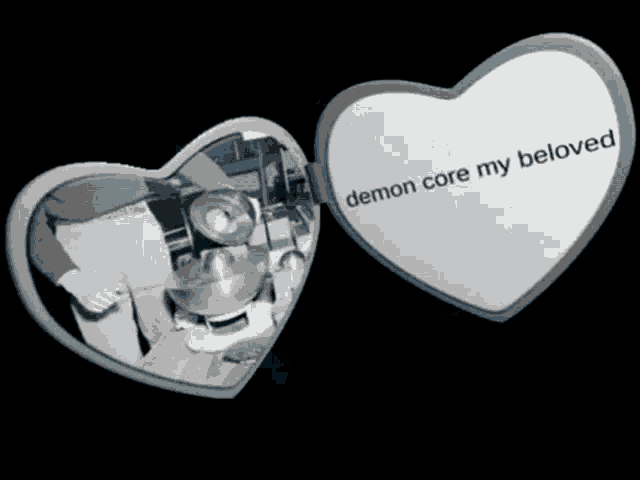 a heart shaped mirror has the words demon core my beloved on it