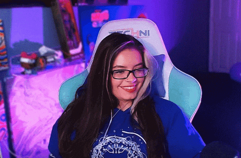 a girl wearing glasses and a techni gaming chair