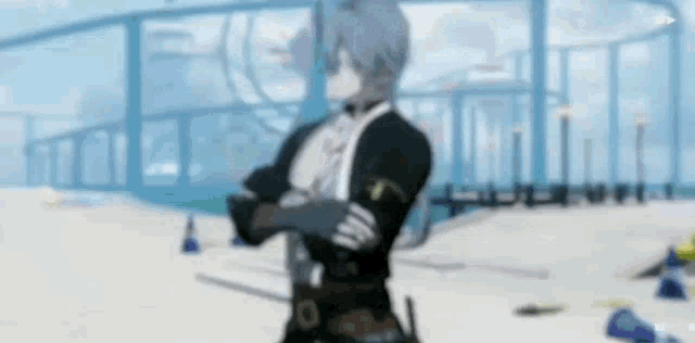 a man with his arms crossed is standing on a beach .