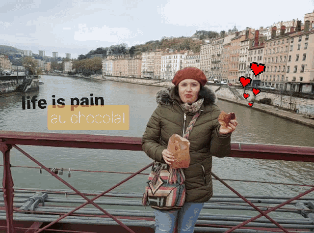 a woman standing on a bridge holding a loaf of bread with the words life is pain at chocolat above her