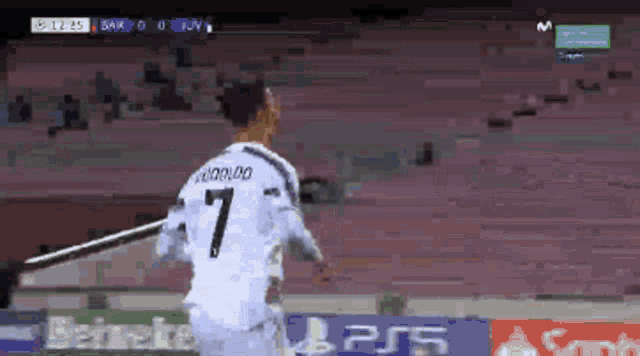 a soccer player wearing a white jersey with the number 7 on it is running on the field .