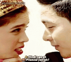 a man and a woman are looking at each other and the woman is wearing a tiara