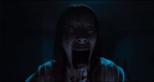 a close up of a person screaming with their mouth open
