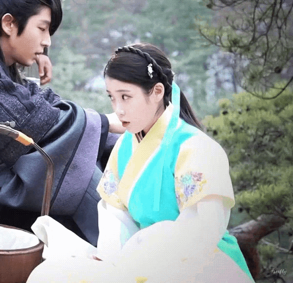 a man and a woman in traditional costume are sitting next to each other