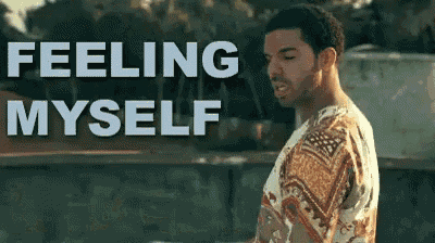 a man standing in front of a sign that says feeling myself .