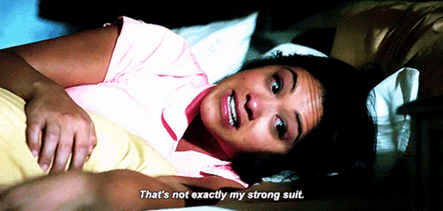 a woman laying in bed with the words that 's not exactly my strong suit on her face
