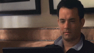 a man is sitting in front of a computer looking at it