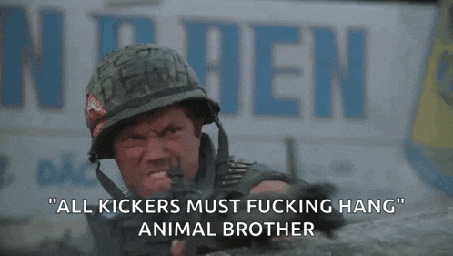 a man in a helmet is holding a gun with the words " all kickers must fucking hang animal brother " below him
