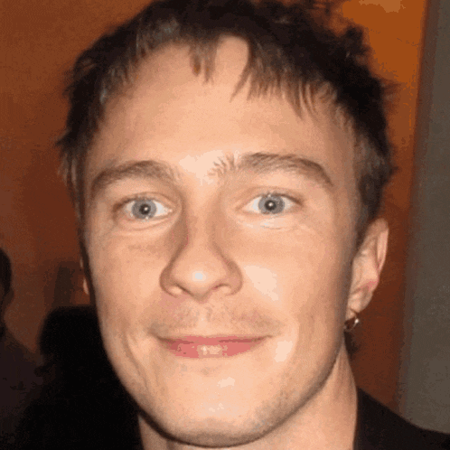 a close up of a man 's face with a smile