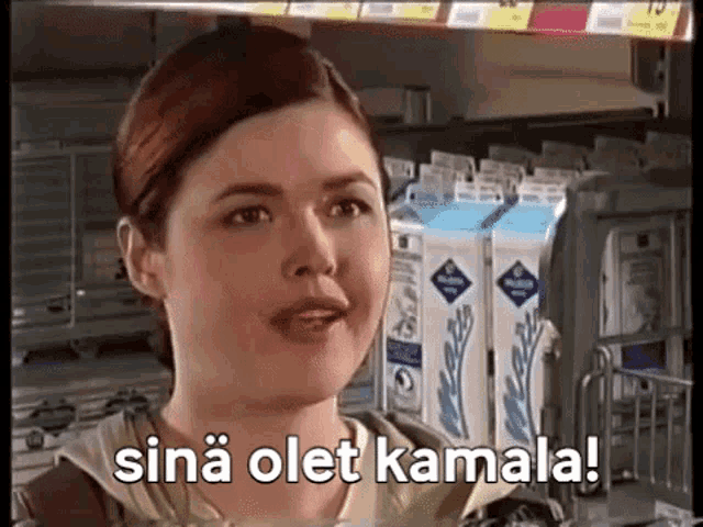 a woman in a store with the words sina olet kamala written on the screen