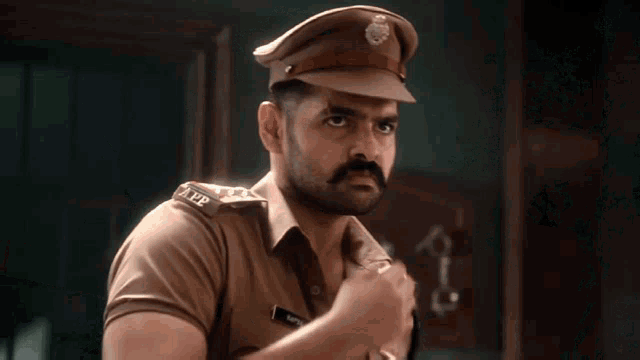 a man in a police uniform has the number 102 on his collar