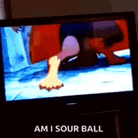 a television screen shows a cartoon character 's foot and the words `` am i sour ball '' .