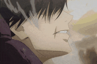 a close up of a man 's face with a purple shirt on