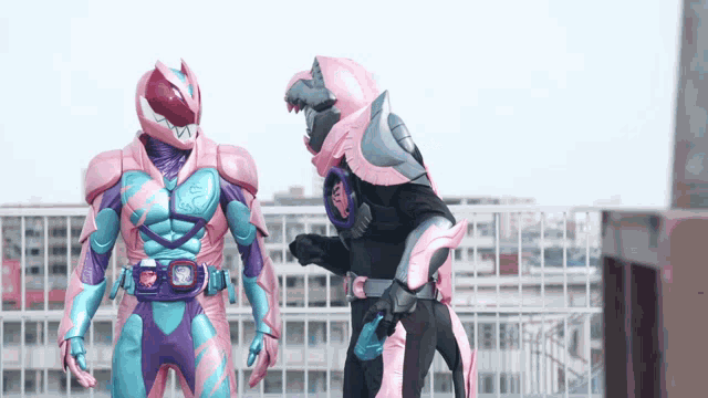 two kamen riders are standing next to each other on a balcony