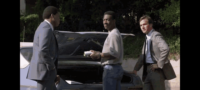 a man in a suit is shaking hands with another man in a suit