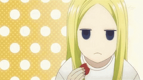 a girl with long blonde hair is eating a strawberry with a yellow and white polka dot background