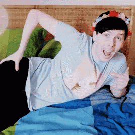 a man is laying on a bed with a flower crown on his head