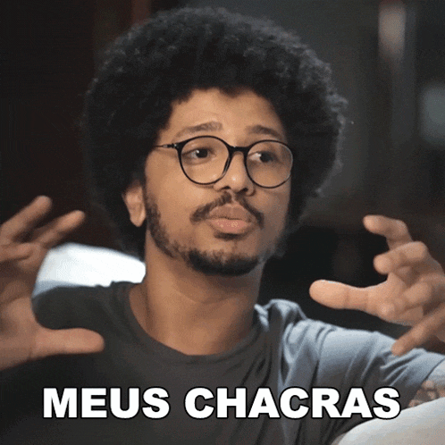 a man with glasses and a beard is making a funny face with the words meus chacras below him