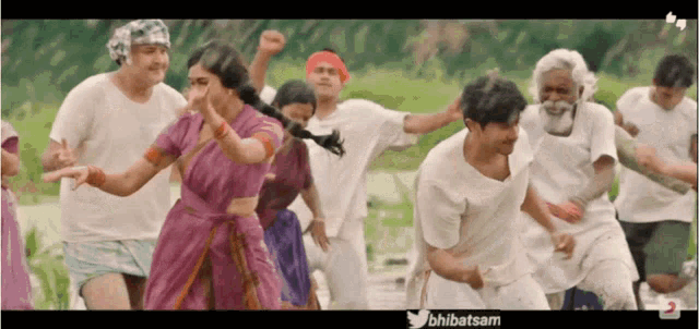 a group of people are dancing in a video that says ' bhibatsam ' at the bottom
