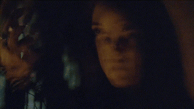 a blurred image of a person 's face with a black background