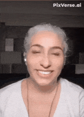 a woman wearing headphones is smiling and making a funny face .