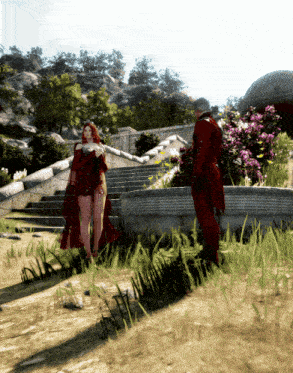 a woman in a red dress is standing next to a man