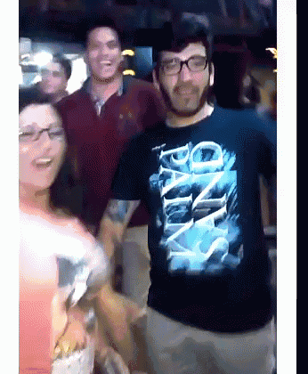 a man wearing a t-shirt that says ' one way ' is standing in front of a group of people