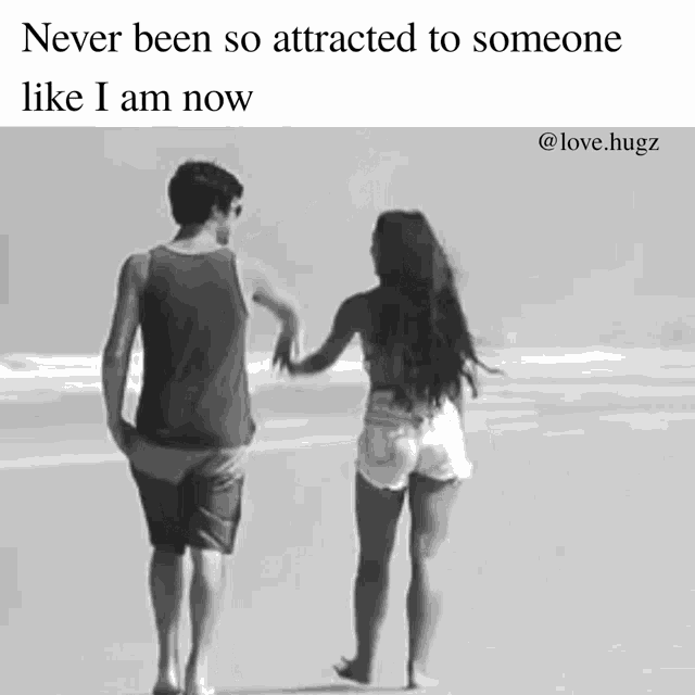 a black and white photo of a man and a woman walking on the beach