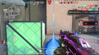 a person is playing a video game with a purple gun and a green box .
