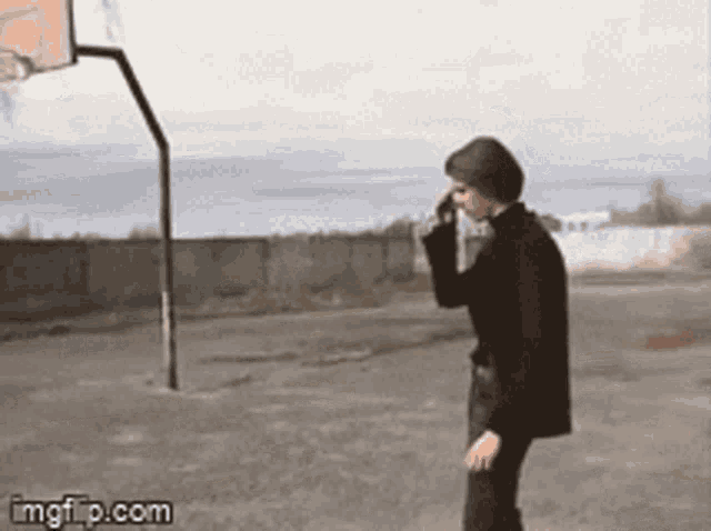 a person standing in front of a basketball hoop with imgflip.com in the corner