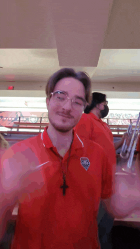 a man wearing a red shirt with a tigers logo on the front