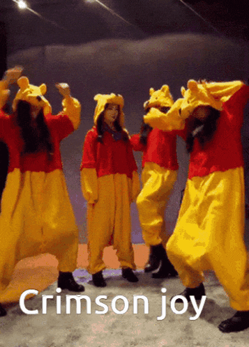 a group of women dressed in winnie the pooh costumes are dancing together
