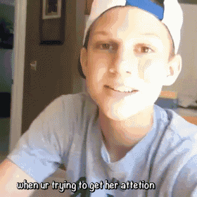 a boy wearing a hat and a blue shirt says when ur trying to get her attention