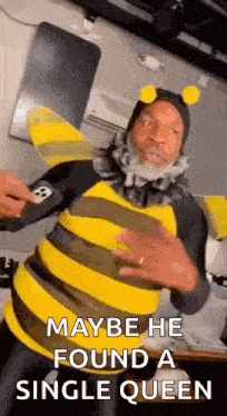 a man in a bee costume is dancing and saying maybe he found a single queen .