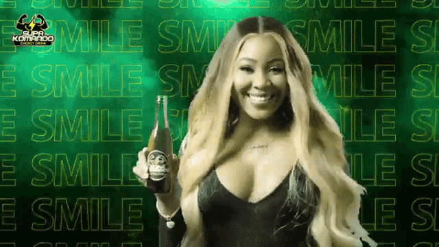 a woman is smiling while holding a bottle in front of a green background with the word smile on it