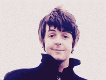 a young man with a collared jacket is smiling