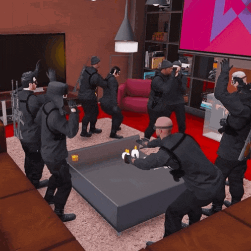 a group of men in black standing around a table