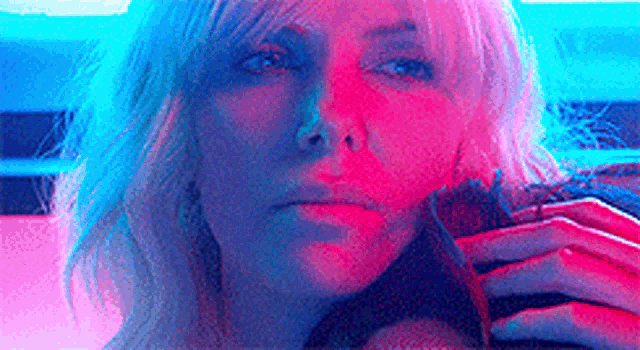 a close up of a woman 's face with a red and blue background