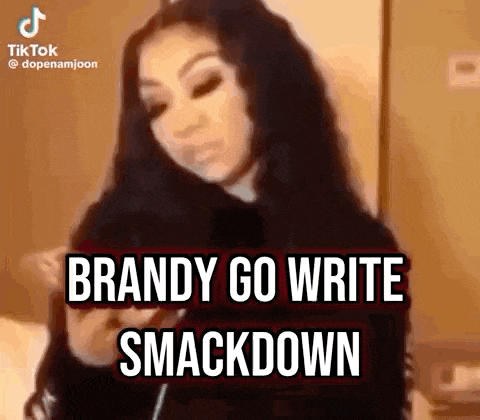 a woman is standing in front of a wall with the words `` brandy go write smackdown '' written on the screen .