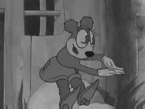 a black and white cartoon of a dog riding a skateboard in front of a wooden building .